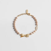 DIOR CD Bow Bracelet Gold-Finish Metal and Iridescent Pink Resin Pearls #385651